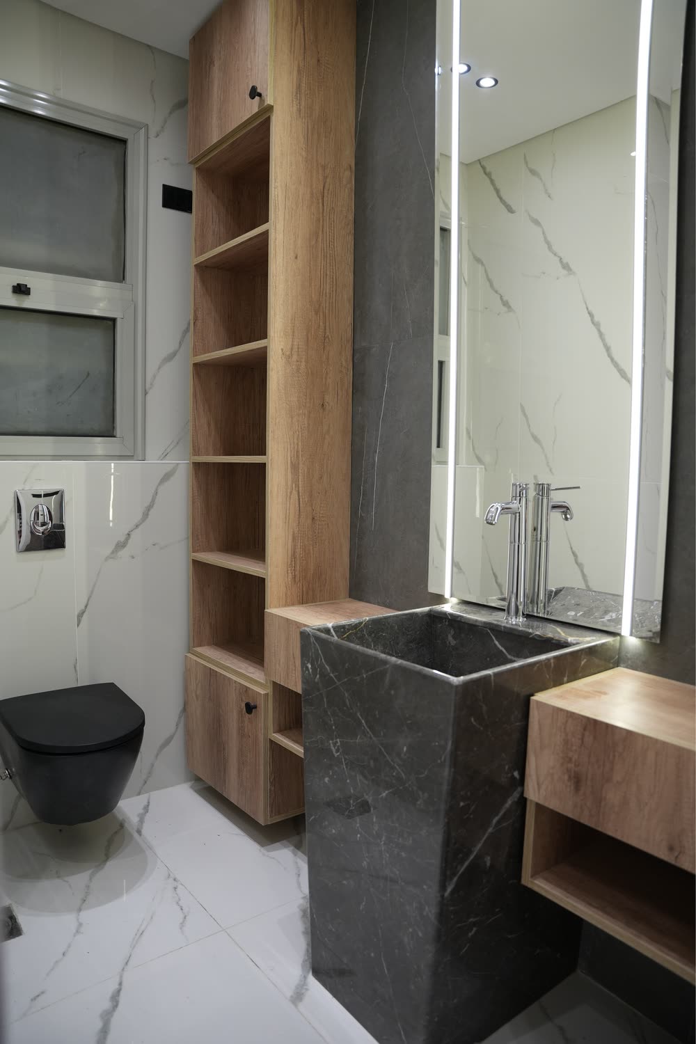 Palm Parks bathroom with stone pedestal basin and backlit mirror