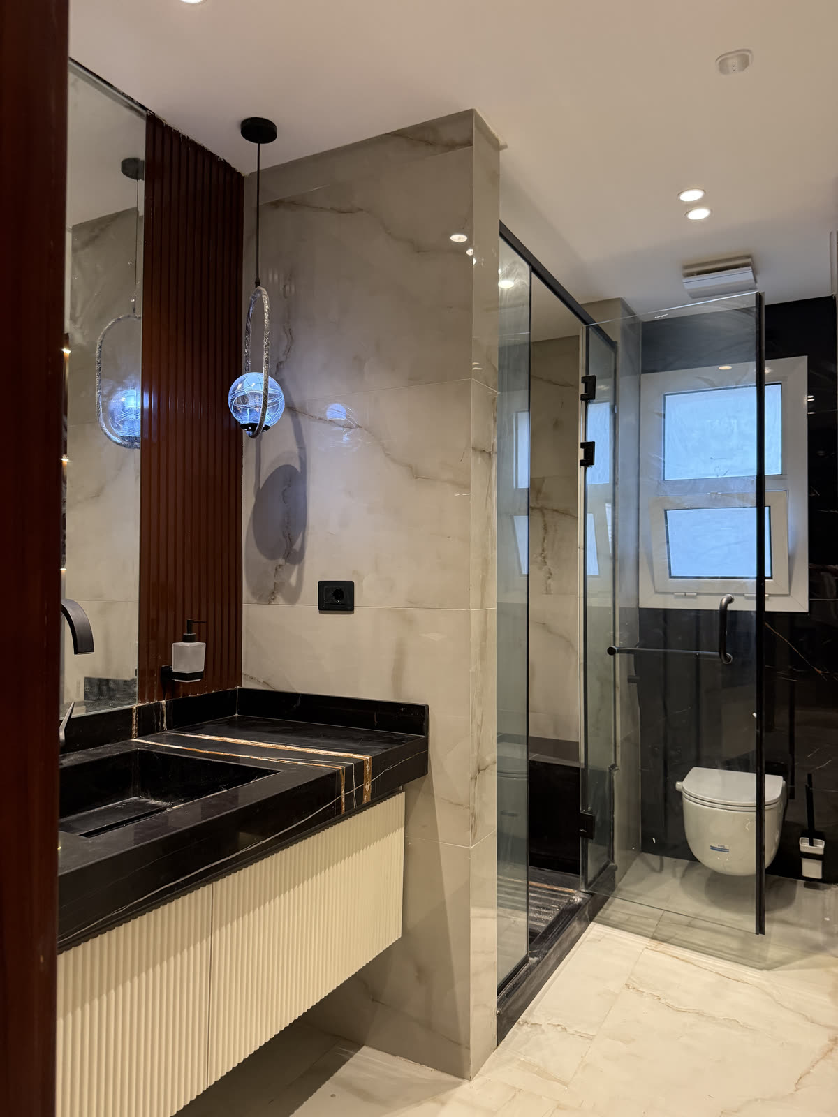 Hyde Park villa bathroom with stone vanity and glass shower